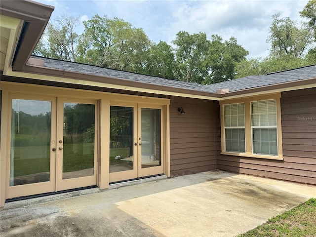 property entrance featuring a patio area and french doors