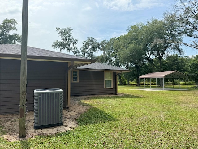 view of yard featuring central AC and a carport