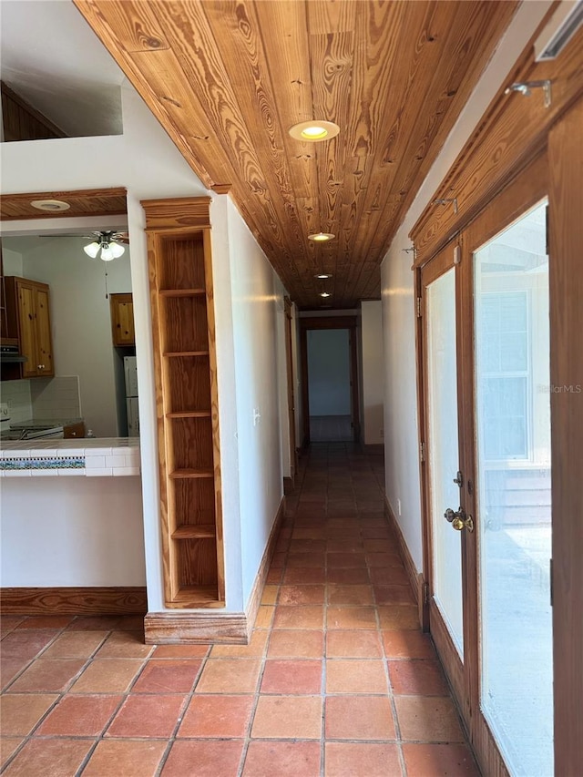 hallway featuring tile flooring, built in features, french doors, and wood ceiling