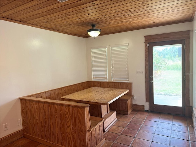 interior space with dark tile flooring and wood ceiling