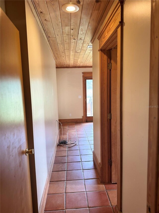 hallway with tile flooring and wood ceiling