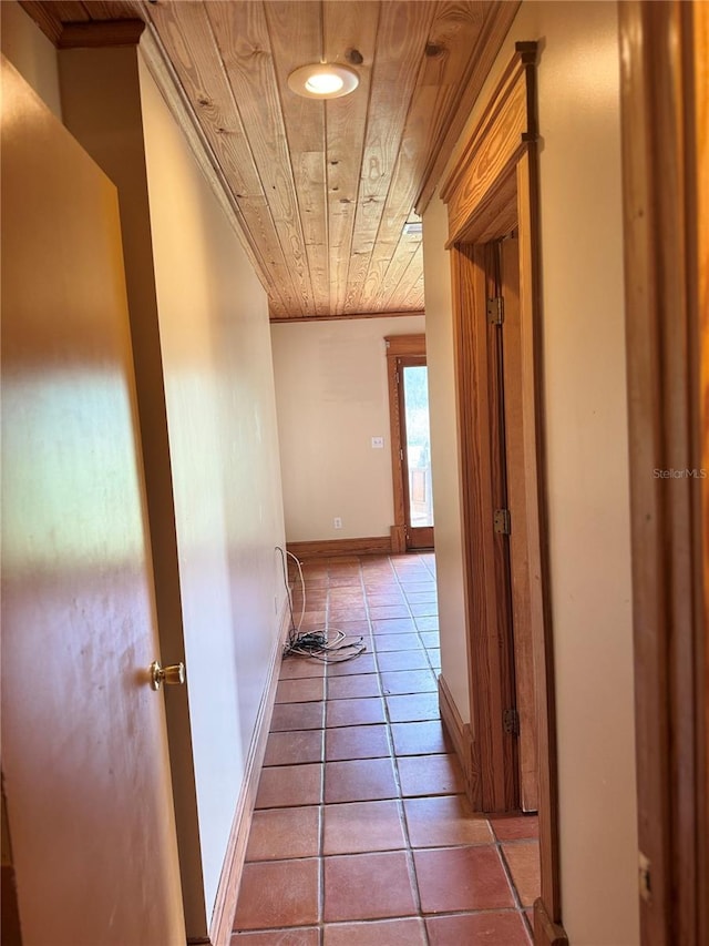 hall featuring wooden ceiling, tile flooring, and ornamental molding