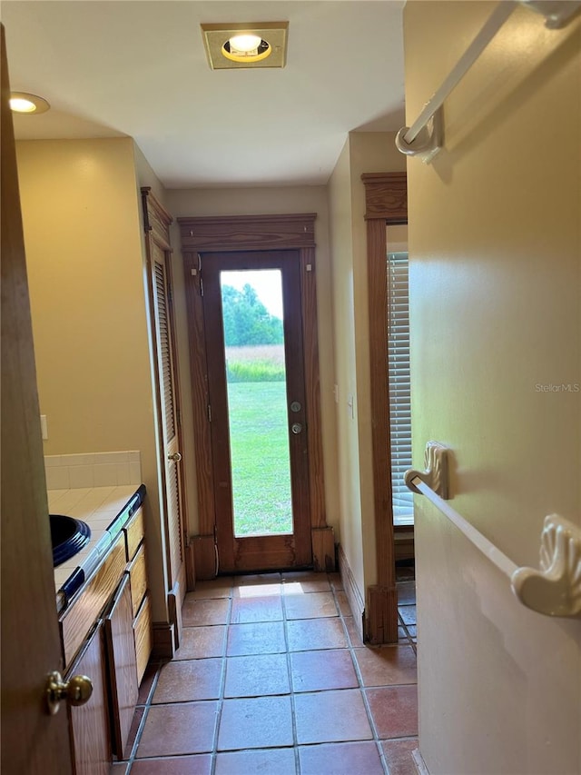 doorway to outside with light tile floors