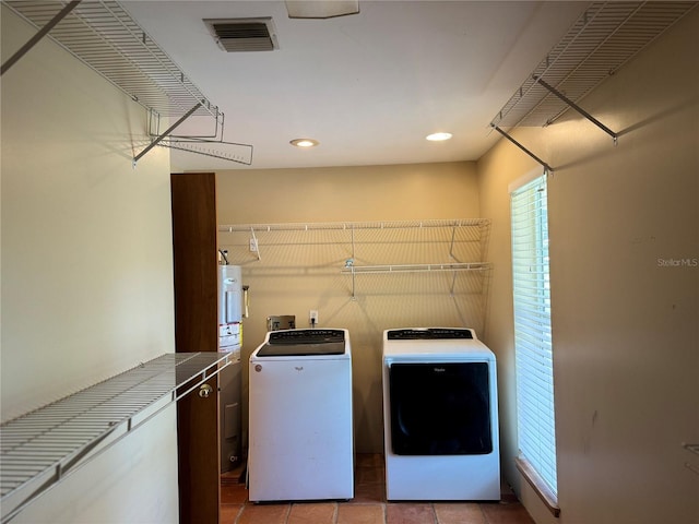 washroom with washer and clothes dryer, tile flooring, and washer hookup