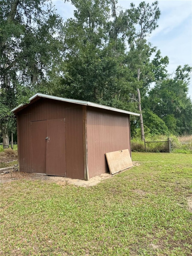 view of outdoor structure with a lawn