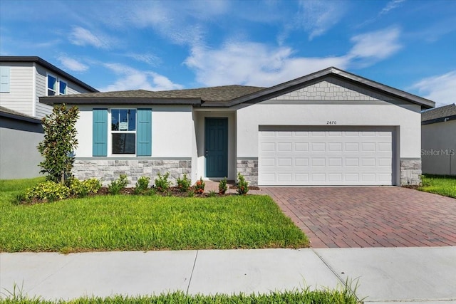 view of front of house with a front yard and a garage