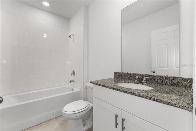 full bathroom with vanity, tiled shower / bath combo, toilet, and tile patterned flooring