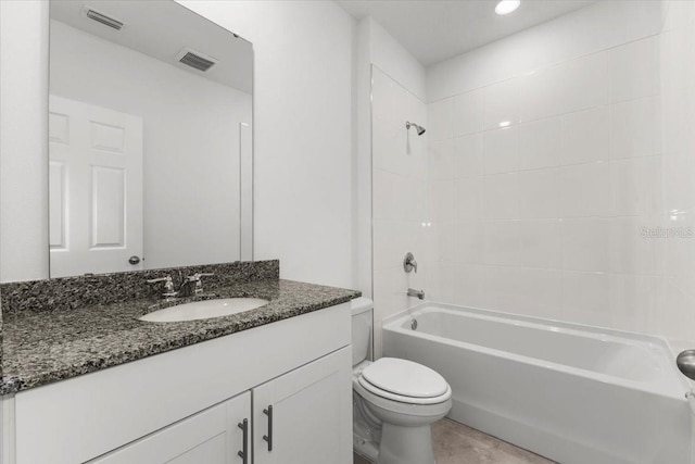 full bathroom with vanity, tiled shower / bath combo, and toilet