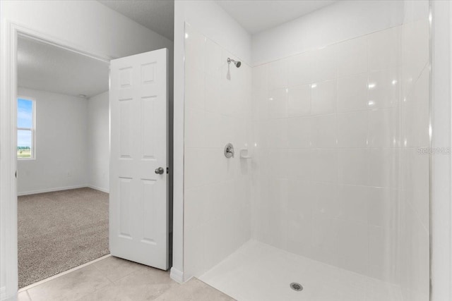 bathroom featuring a tile shower and tile patterned floors