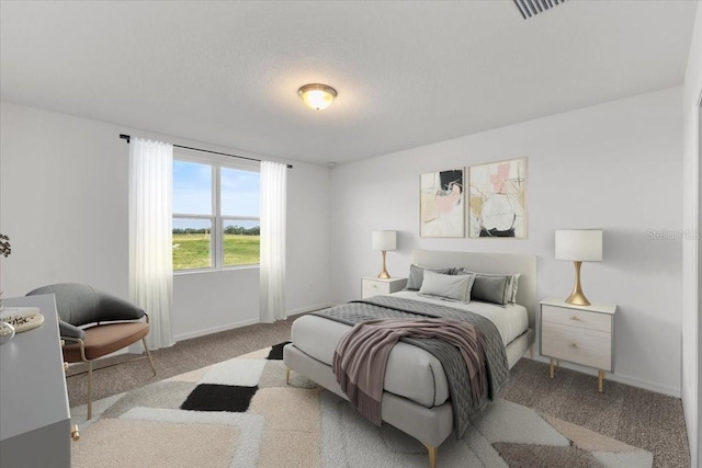 bedroom featuring light carpet and a textured ceiling