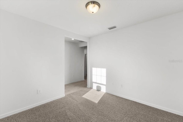 2466 Leeds St, Haines City, FL 33844 - unfurnished room with baseboards, visible vents, and carpet