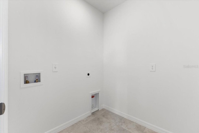 laundry area with electric dryer hookup, washer hookup, and light tile patterned floors