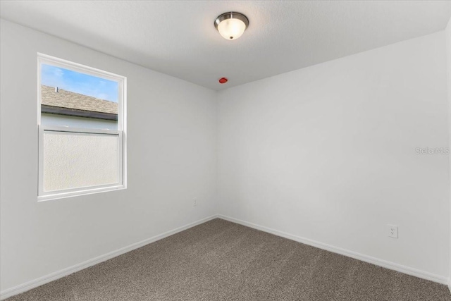 2466 Leeds St, Haines City, FL 33844 - empty room featuring baseboards and carpet