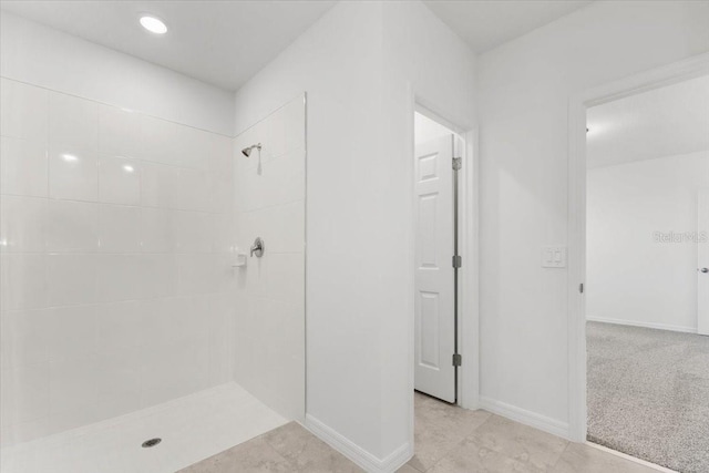 2466 Leeds St, Haines City, FL 33844 - bathroom with baseboards and tiled shower