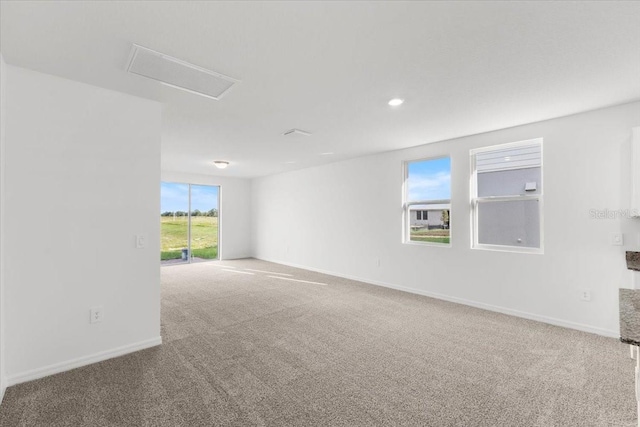 empty room with carpet and a healthy amount of sunlight