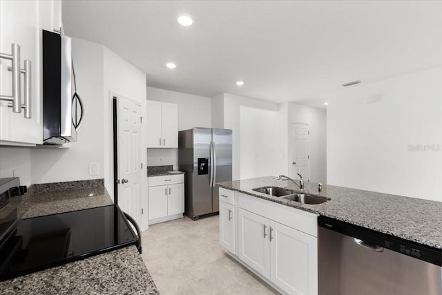 kitchen with white cabinetry, light stone counters, appliances with stainless steel finishes, and sink