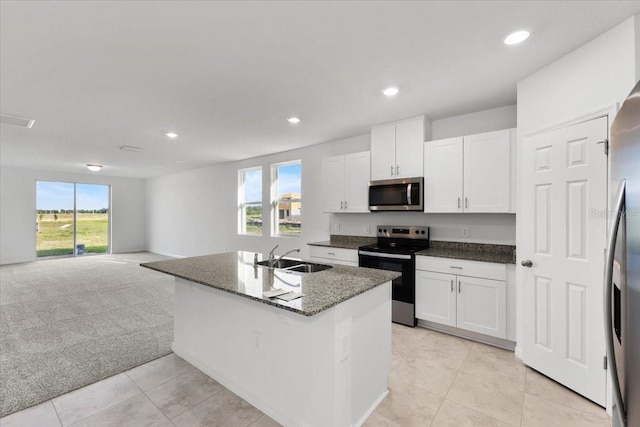 2466 Leeds St, Haines City, FL 33844 - kitchen featuring a sink, light carpet, white cabinets, appliances with stainless steel finishes, and recessed lighting