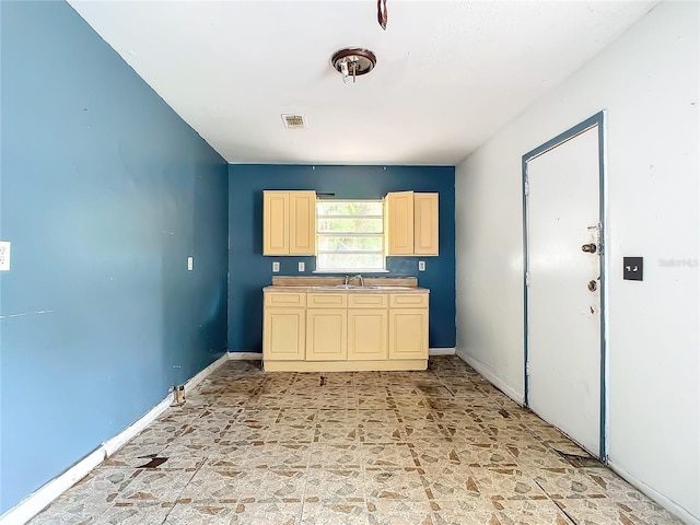 kitchen featuring sink and light tile floors