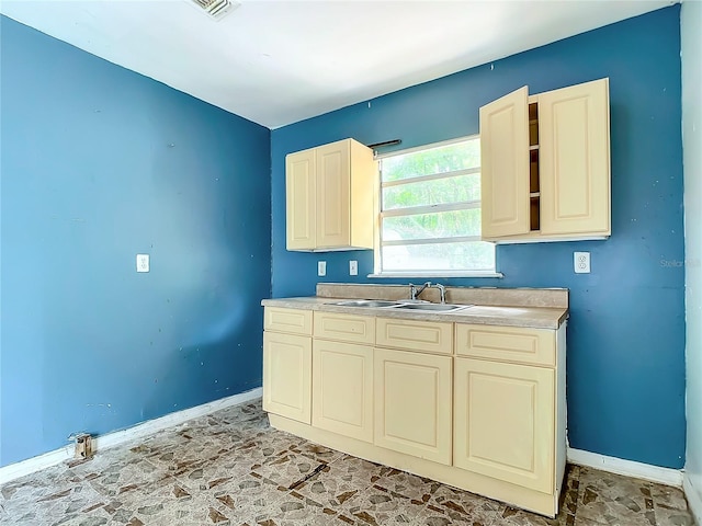 kitchen with sink and light tile floors