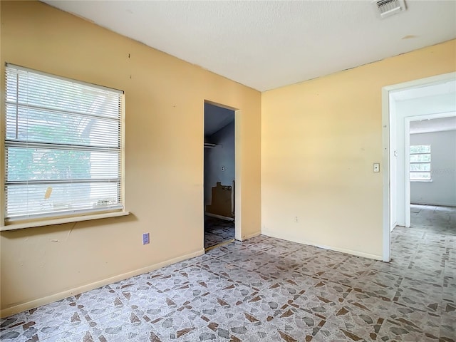 unfurnished room featuring tile floors