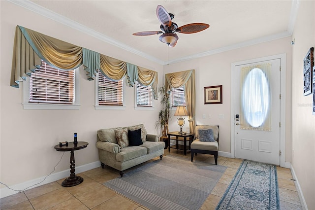 tiled entrance foyer featuring crown molding and ceiling fan