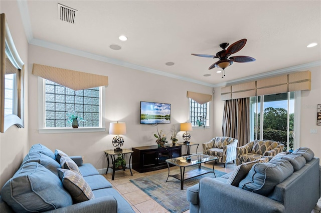 tiled living room with ceiling fan and crown molding