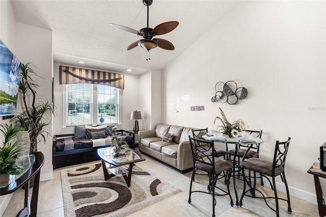 tiled living room featuring high vaulted ceiling and ceiling fan