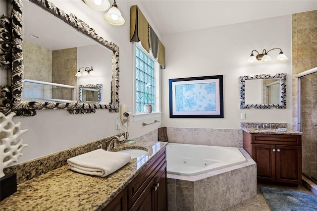 bathroom with dual vanity, a relaxing tiled bath, and tile flooring