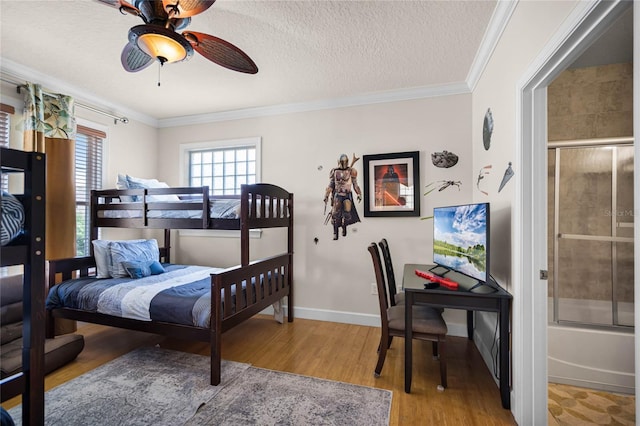 bedroom with a textured ceiling, ceiling fan, hardwood / wood-style floors, and ornamental molding