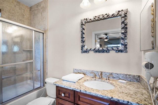 full bathroom featuring shower / bath combination with glass door, vanity, toilet, and ceiling fan