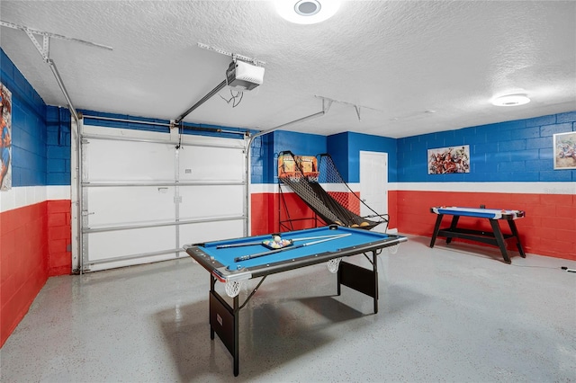 game room with a textured ceiling and pool table