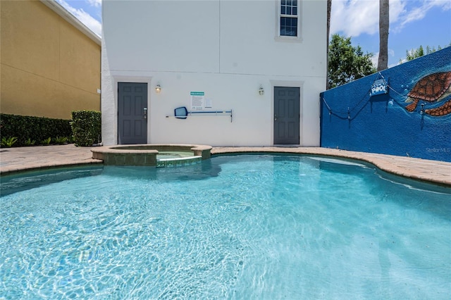 view of pool featuring an in ground hot tub