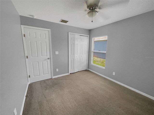 205 Hibiscus St, Winter Haven, FL 33881 - unfurnished bedroom featuring a closet, ceiling fan, baseboards, carpet flooring, and visible vents