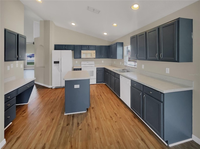 kitchen featuring a center island, sink, light hardwood / wood-style flooring, and white appliances