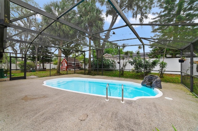 view of swimming pool with glass enclosure and a patio