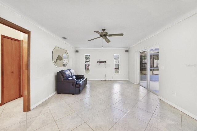 tiled living room with ceiling fan and crown molding