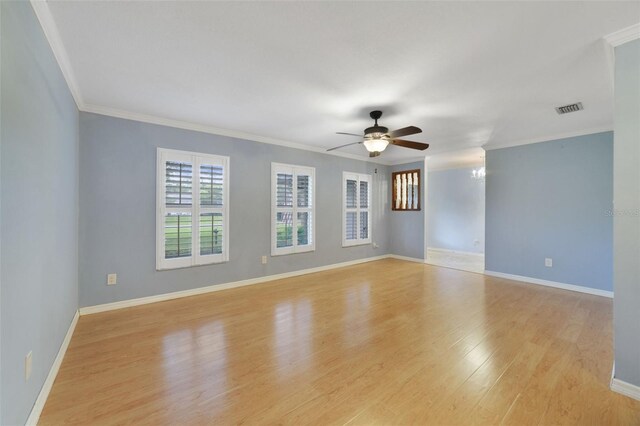 empty room with ceiling fan, light hardwood / wood-style flooring, and ornamental molding