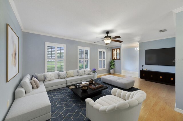 living room featuring light hardwood / wood-style floors, ornamental molding, and ceiling fan