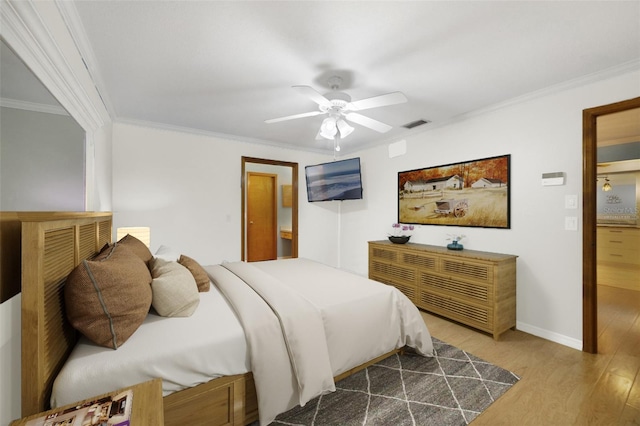 bedroom with ceiling fan, crown molding, and hardwood / wood-style floors