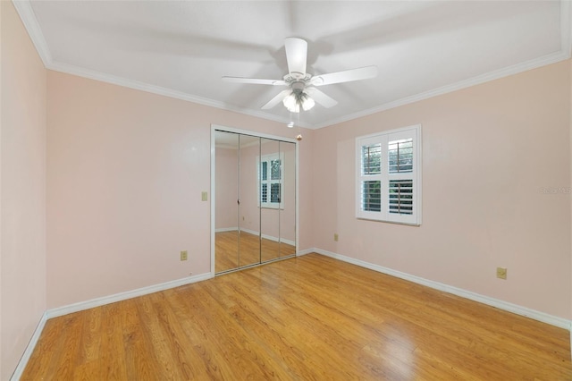 unfurnished bedroom featuring ceiling fan, light wood-type flooring, and ornamental molding