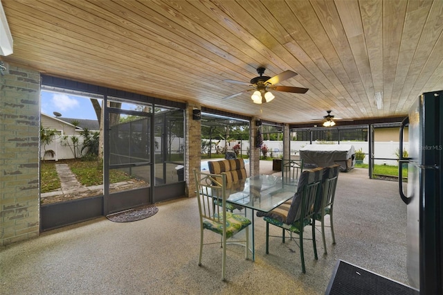 sunroom / solarium with ceiling fan and wooden ceiling