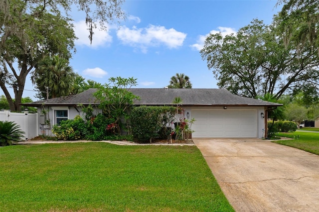 ranch-style home with a front yard and a garage