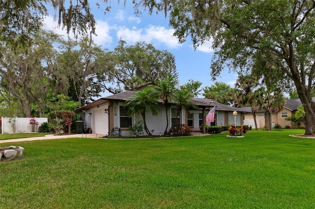 ranch-style house featuring an attached garage, driveway, fence, and a front yard