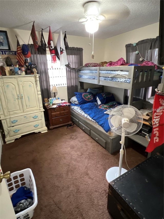 bedroom with ceiling fan, a textured ceiling, and carpet flooring