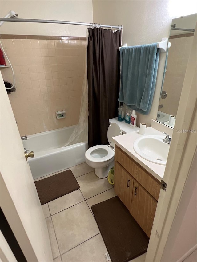 full bath with toilet, tile patterned flooring, shower / tub combo with curtain, and vanity