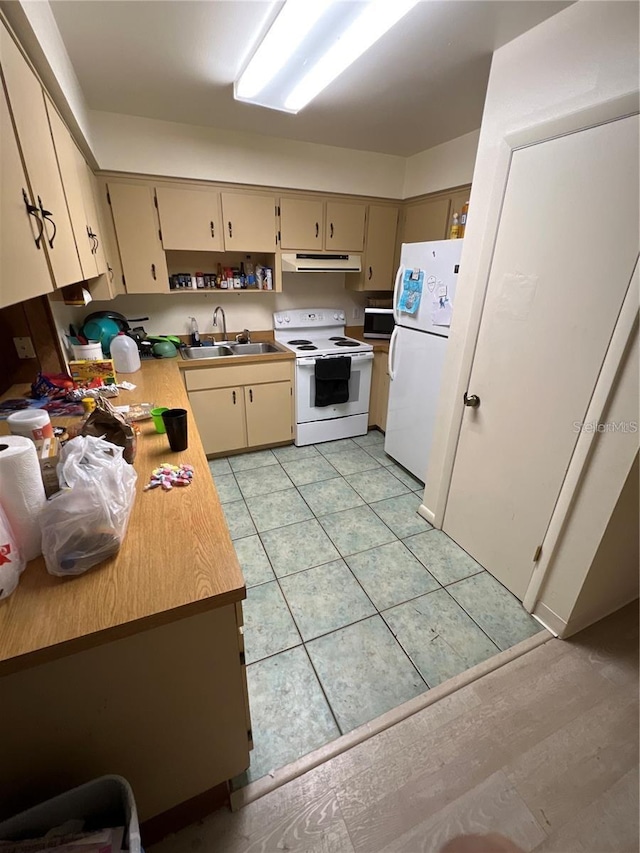 kitchen with cream cabinets, light tile patterned flooring, a sink, white appliances, and extractor fan