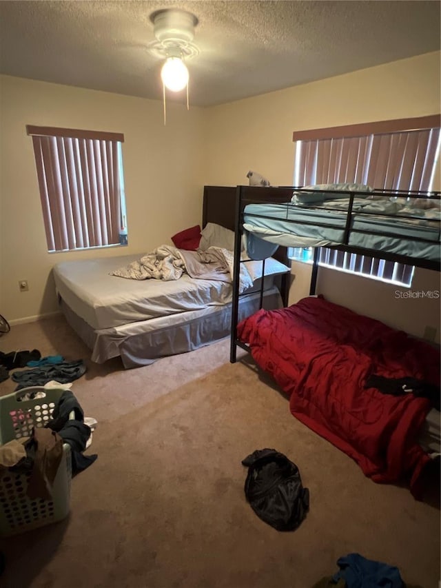 bedroom featuring carpet and a textured ceiling