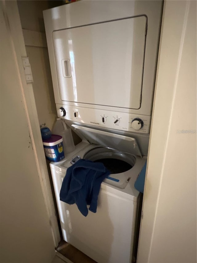 laundry room featuring stacked washer and dryer and laundry area