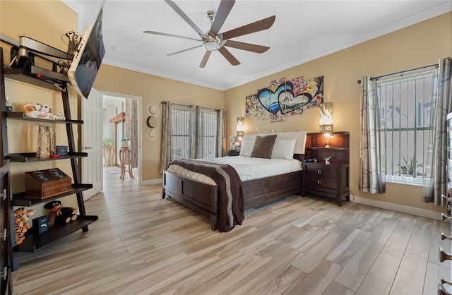 bedroom with multiple windows, ornamental molding, ceiling fan, and light hardwood / wood-style flooring