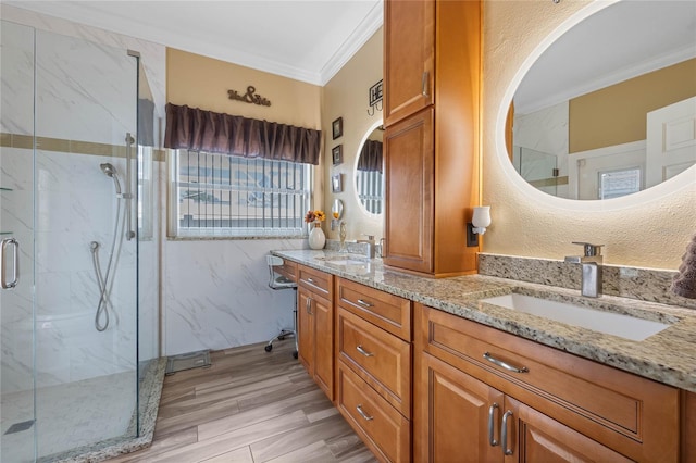 bathroom featuring walk in shower, ornamental molding, dual sinks, and large vanity